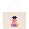 A white tote bag with a printed image of a perfume bottle and colorful flowers on it.