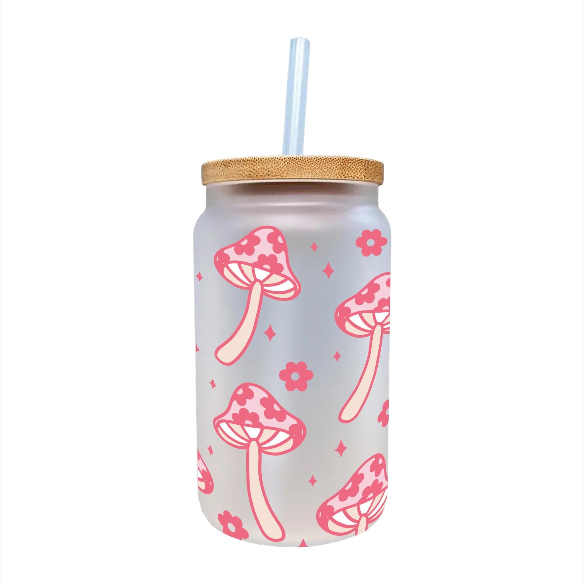 a pink and white cup with a straw in it