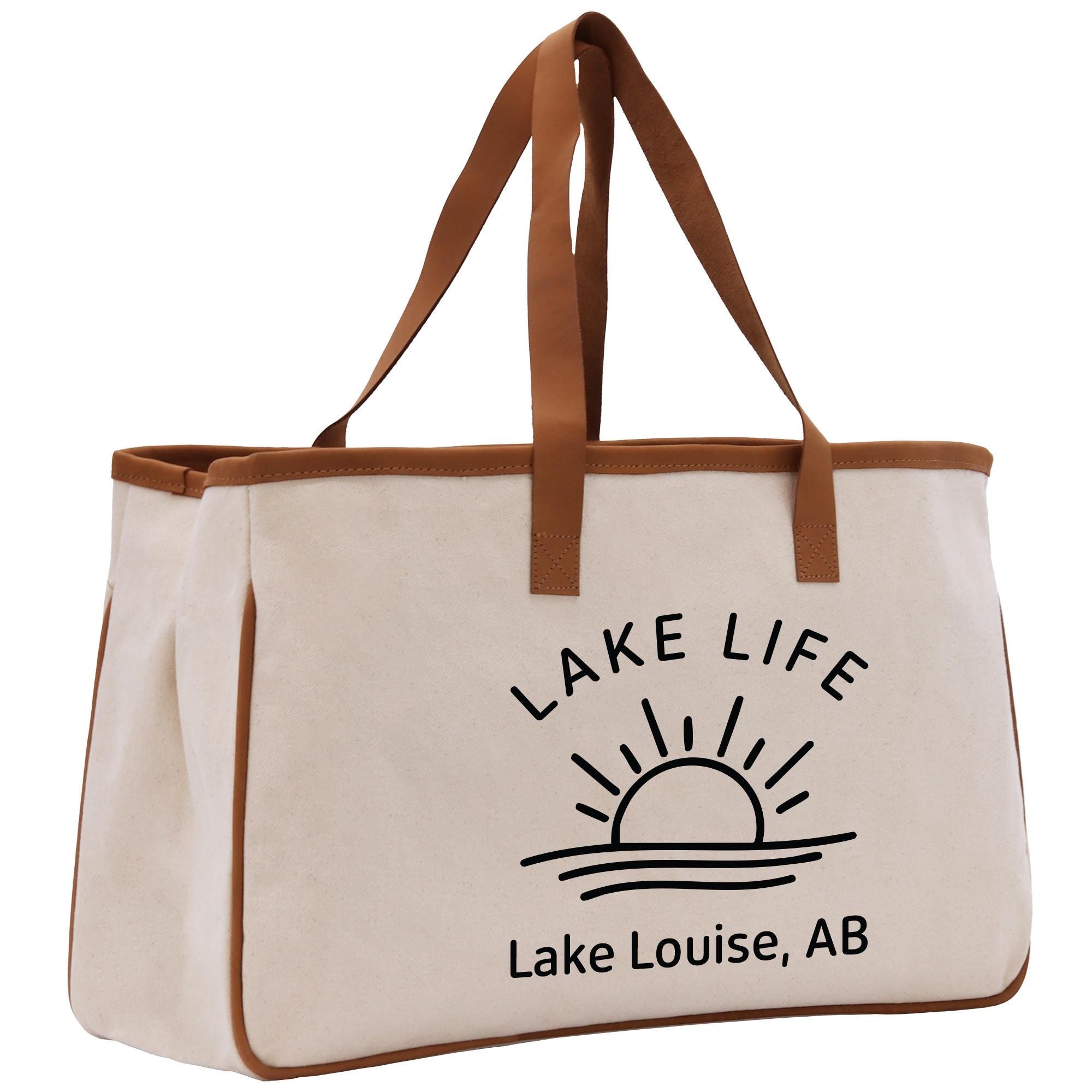 a white bag with a brown handle and a lake life logo on it