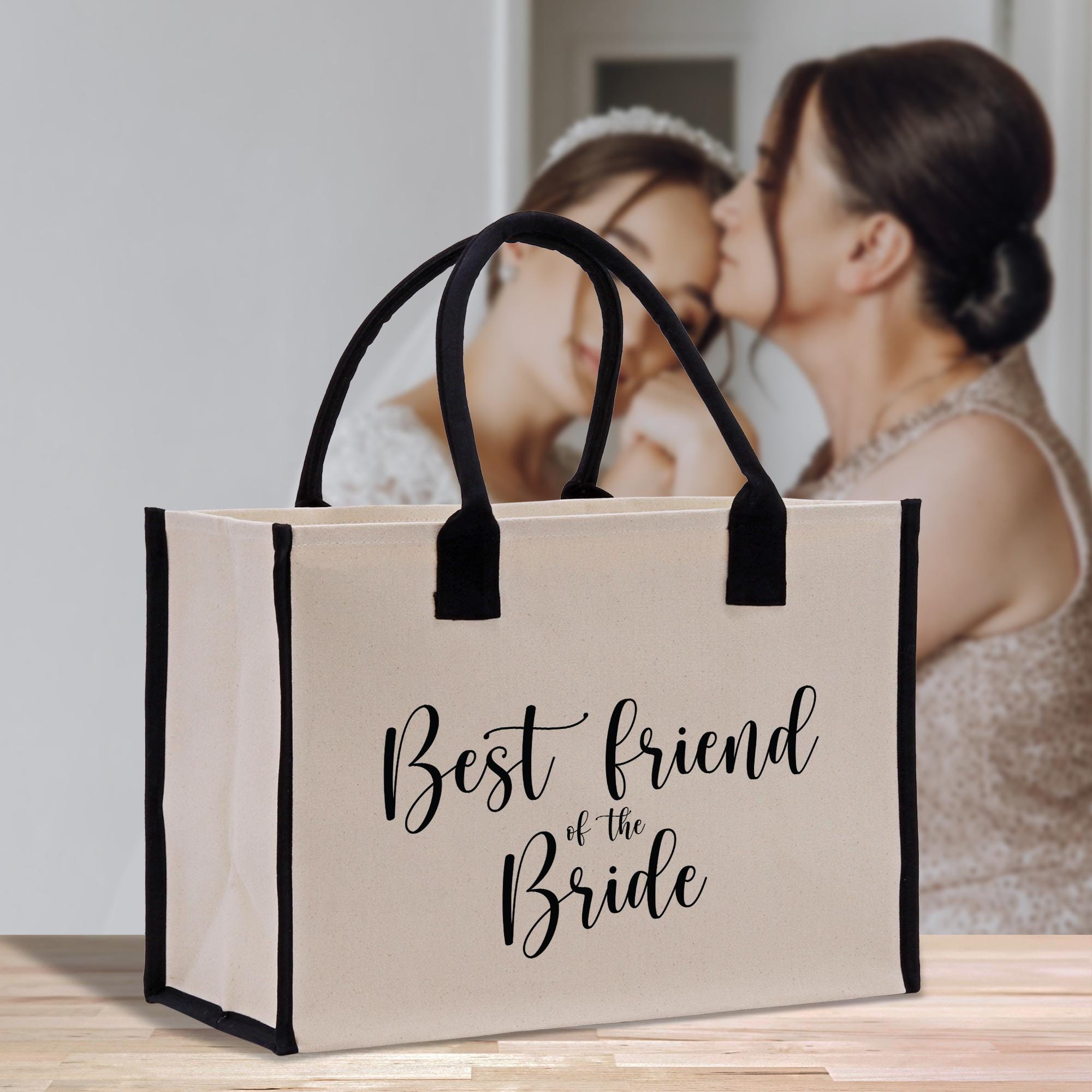 a woman kissing a woman&#39;s face while holding a shopping bag