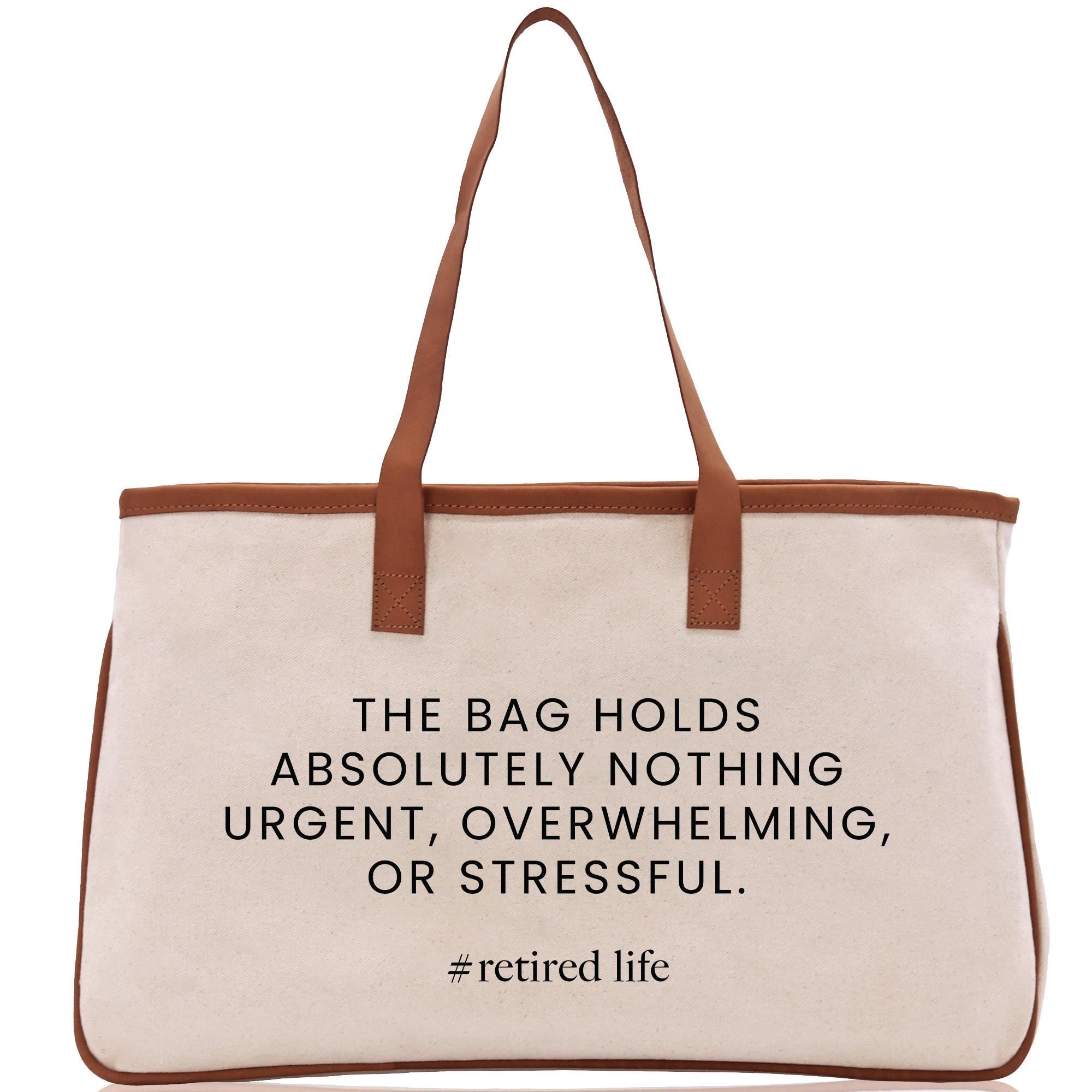 a beige tote bag with a brown strap and a printed quote on it.