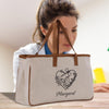 a woman is holding a bag with a picture on it