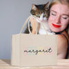 a woman holding a cat and a shopping bag