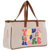 a canvas tote bag with the words you're here printed on it