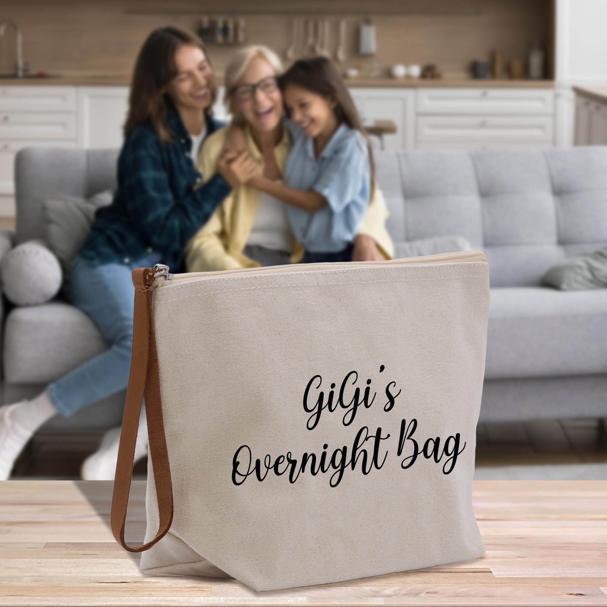 two women sitting on a couch with a bag in front of them