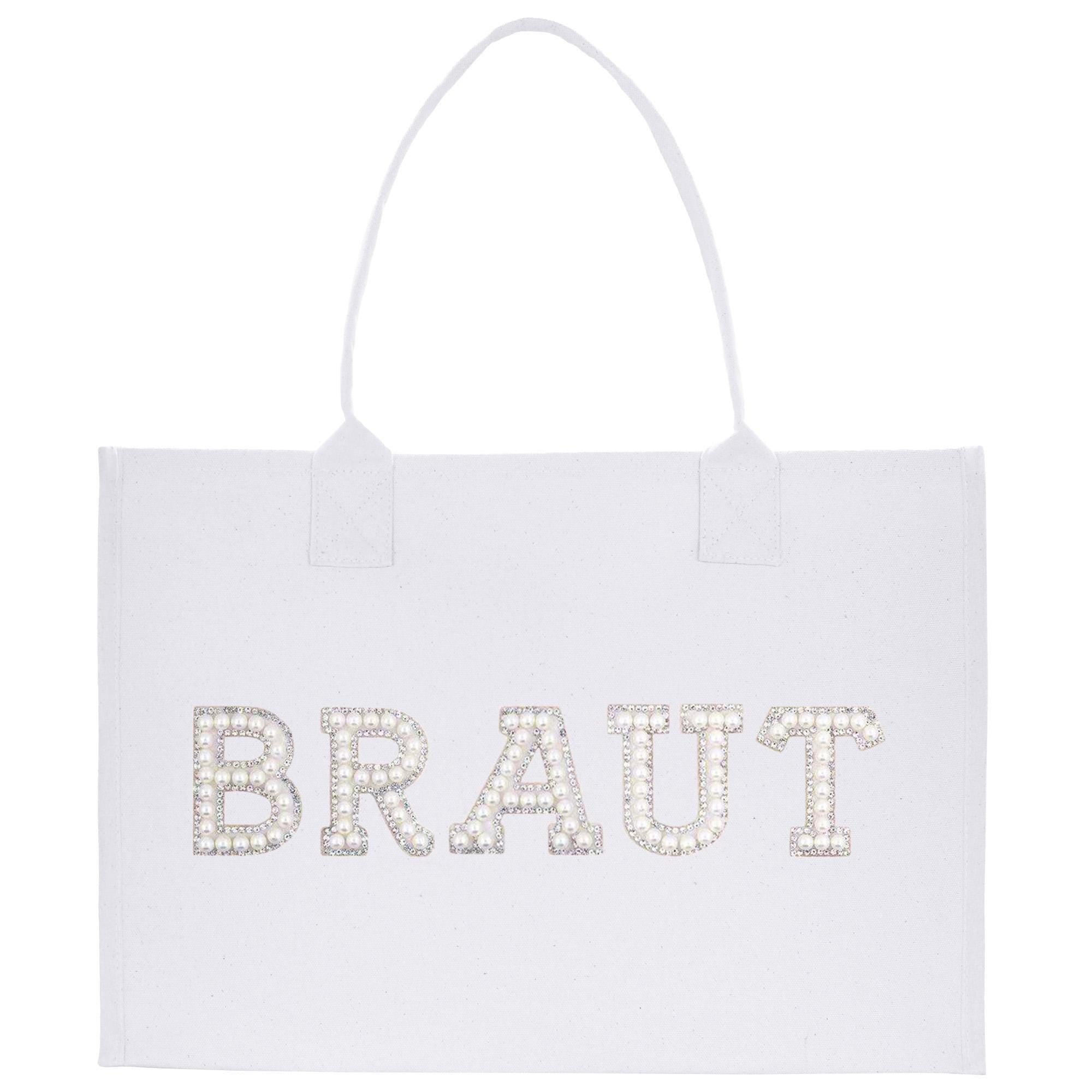 A white tote bag with the word &quot;BRAUT&quot; printed on it in large letters.