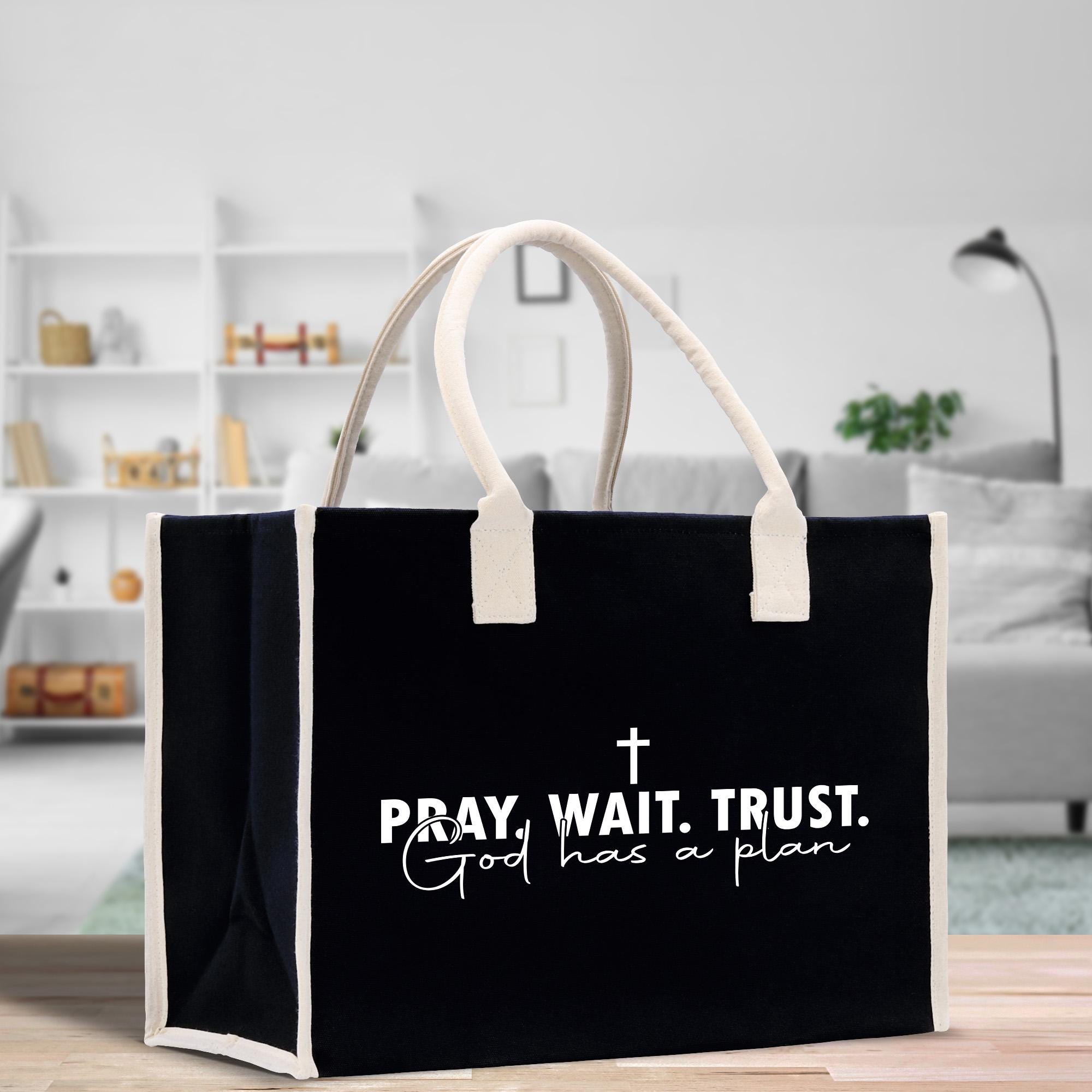 a black and white bag with a cross on it