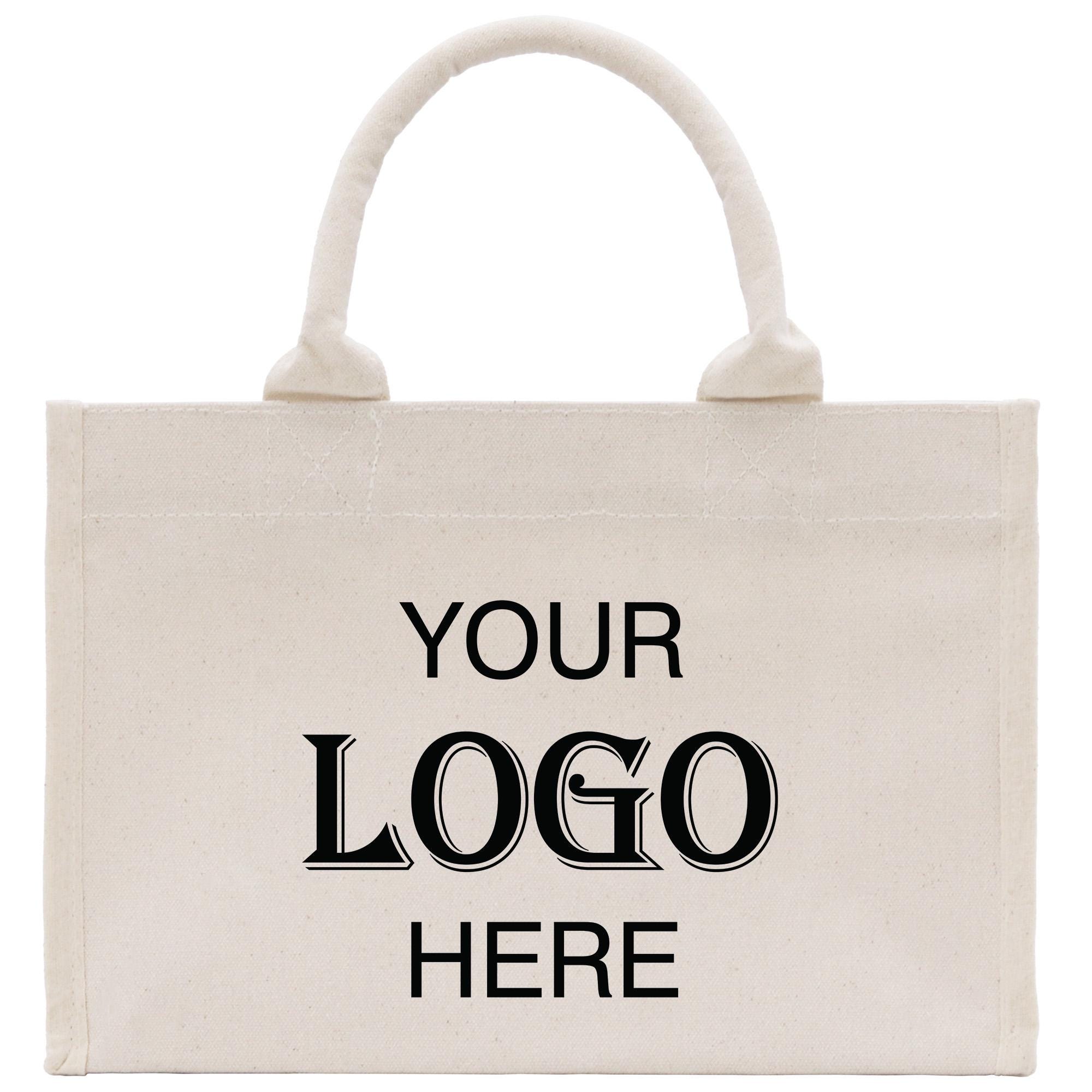 A beige canvas tote bag with the text &quot;YOUR LOGO HERE&quot; printed on it.