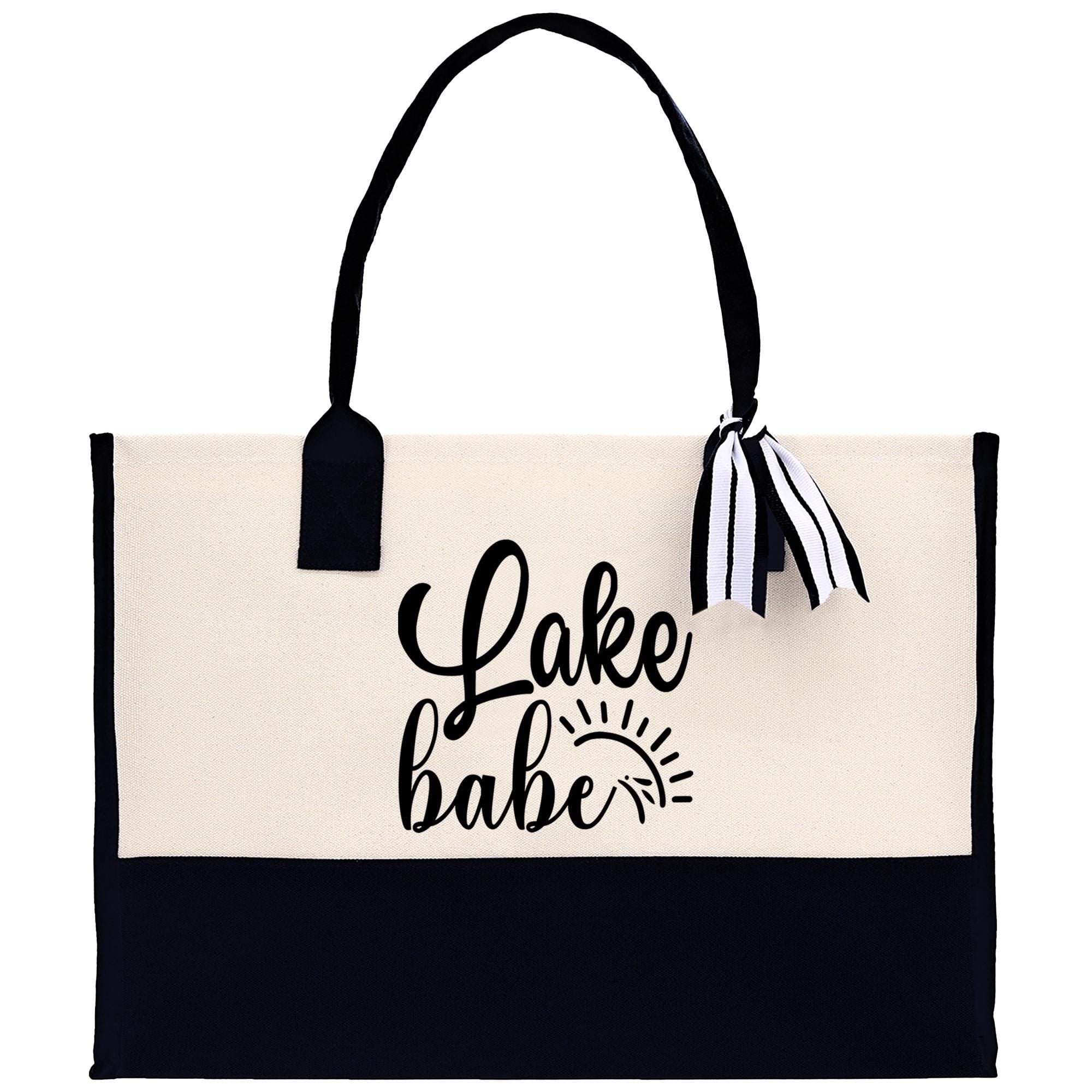 A black and white tote bag with the text "Lake Babe" printed on it.