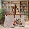 A beige tote bag with a printed design of books and a plant, along with the text "I HAVE NO SHELF CONTROL".