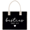 A black tote bag with white text and a heart symbol, indicating "Besties Since 2017".