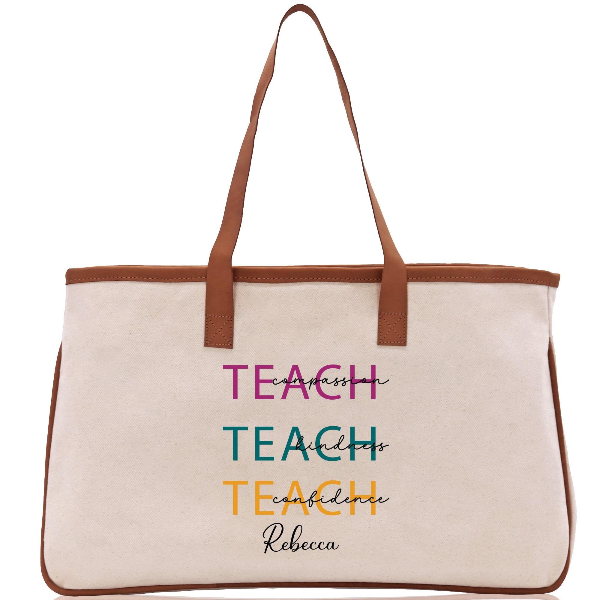 a white canvas bag with a brown leather handle