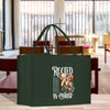 a green bag sitting on top of a wooden table