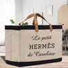 a canvas bag with leather handles on a table