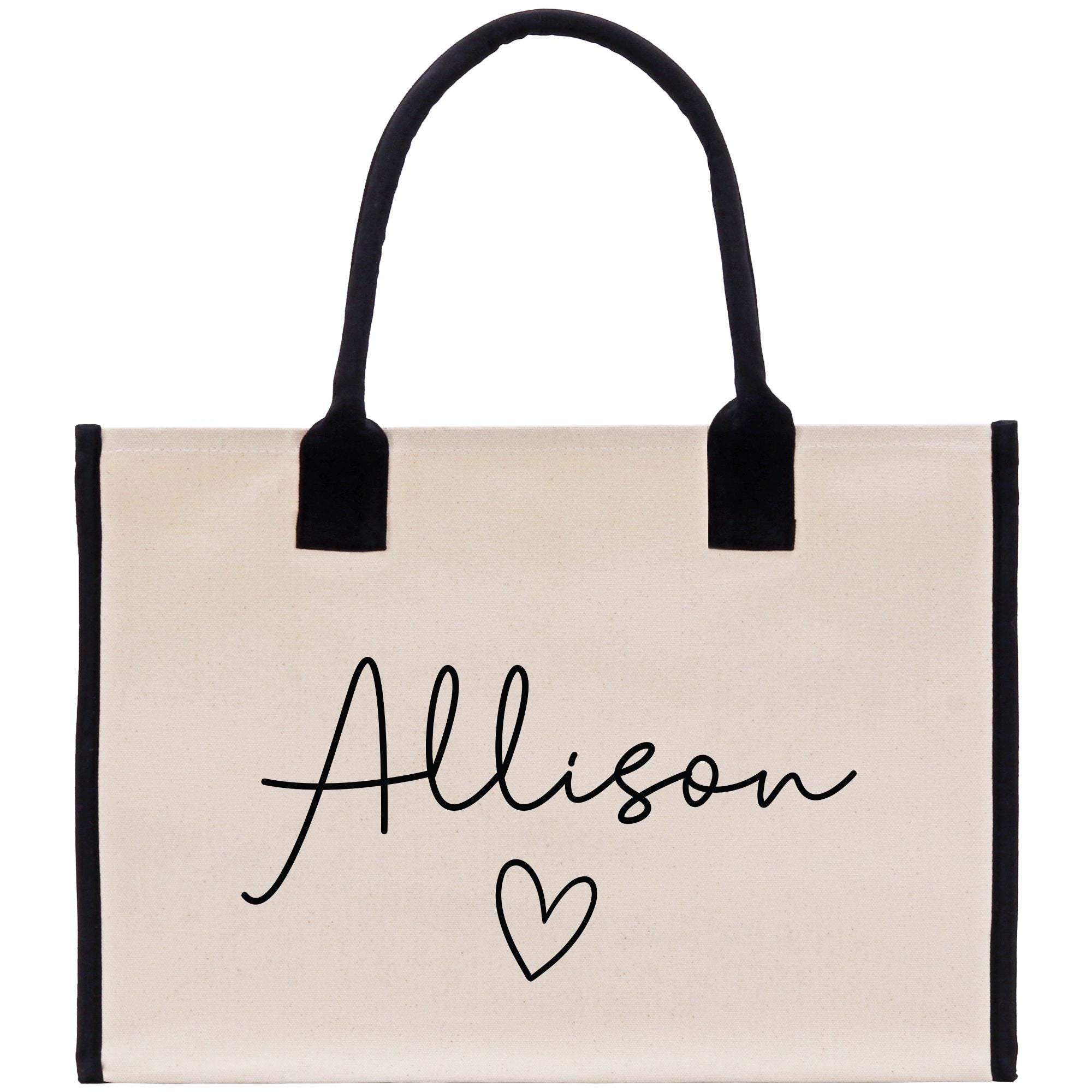 a white bag with a black handle and a name on it