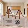 Two beige tote bags with brown handles, each carrying the text "WALKER & JEN" and "Real Estate" printed on them. The bags are placed on a wooden surface, with a kitchen visible in the background.