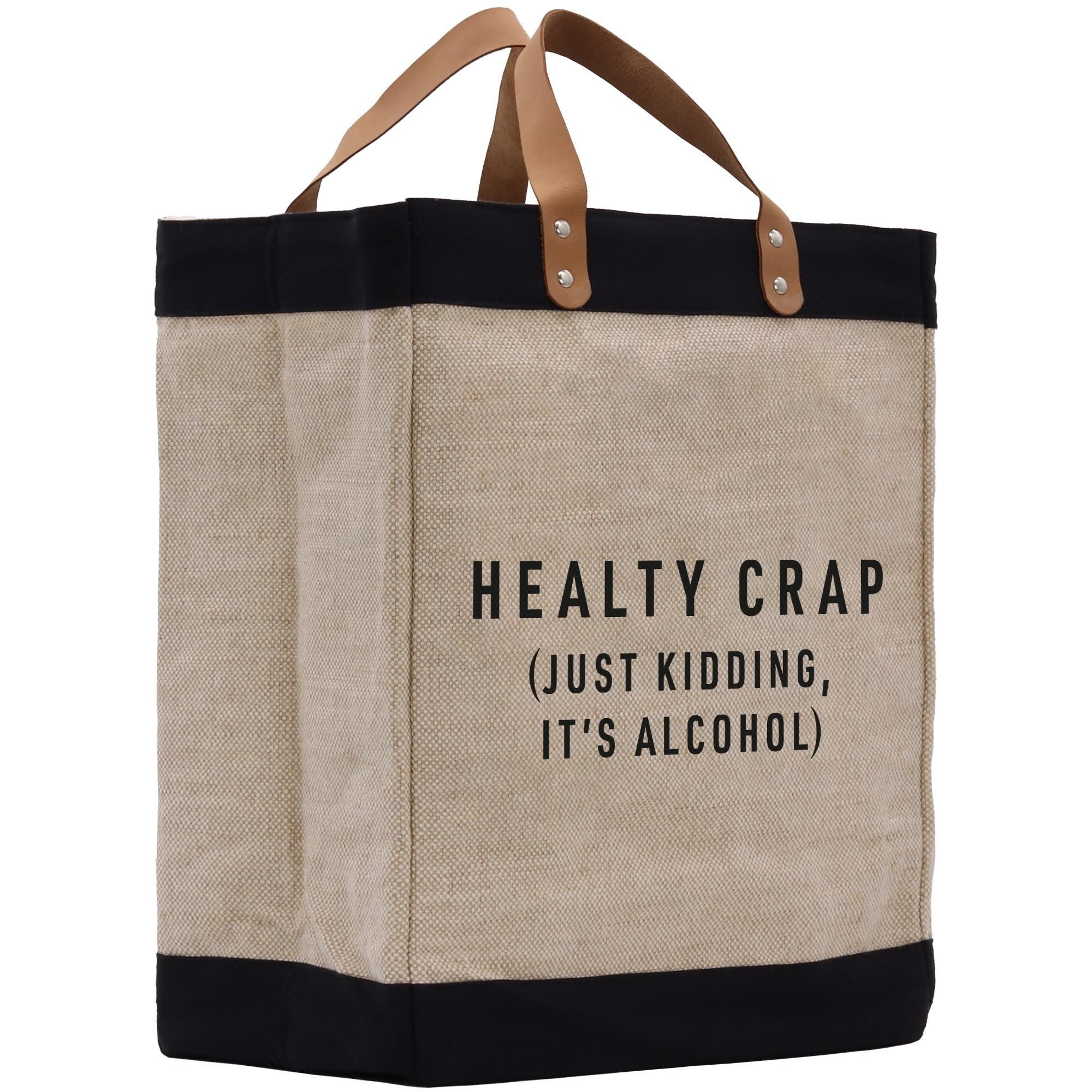 A beige tote bag with black trim and leather handles, featuring a humorous text printed on it.