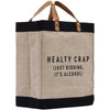 A beige tote bag with black trim and leather handles, featuring a humorous text printed on it.