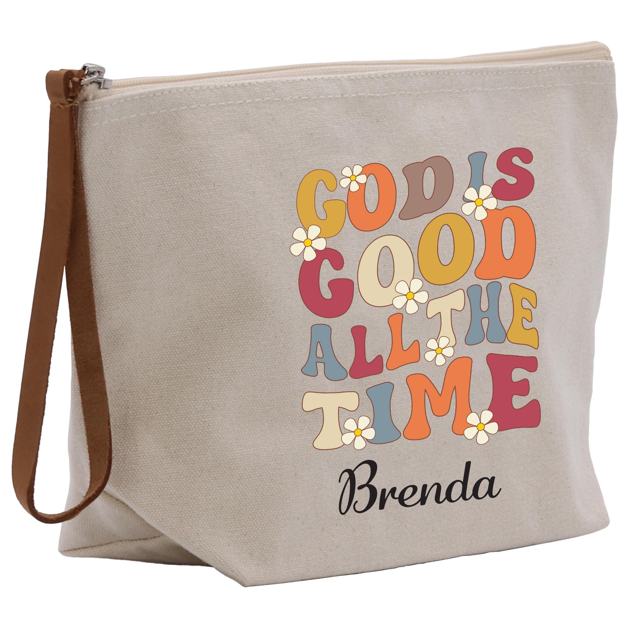 A beige canvas tote bag with a colorful graphic design featuring the text &quot;GOOD IS GOD GOOD ALL THE TIME&quot; and the name &quot; Brenda&quot; printed on it.