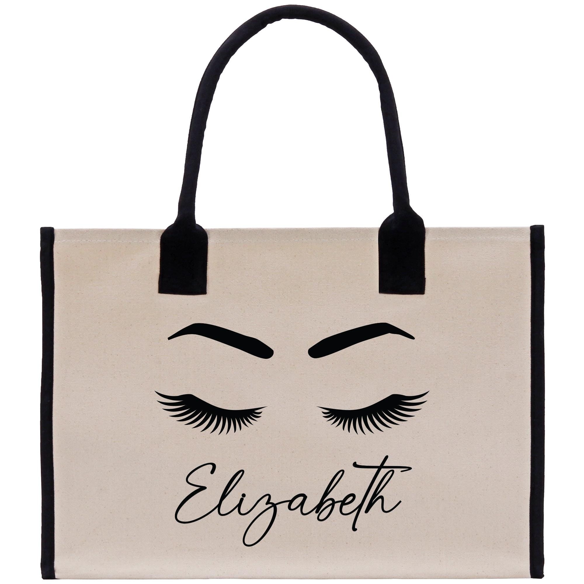 a canvas bag with eyelashes and the word elizabeth on it