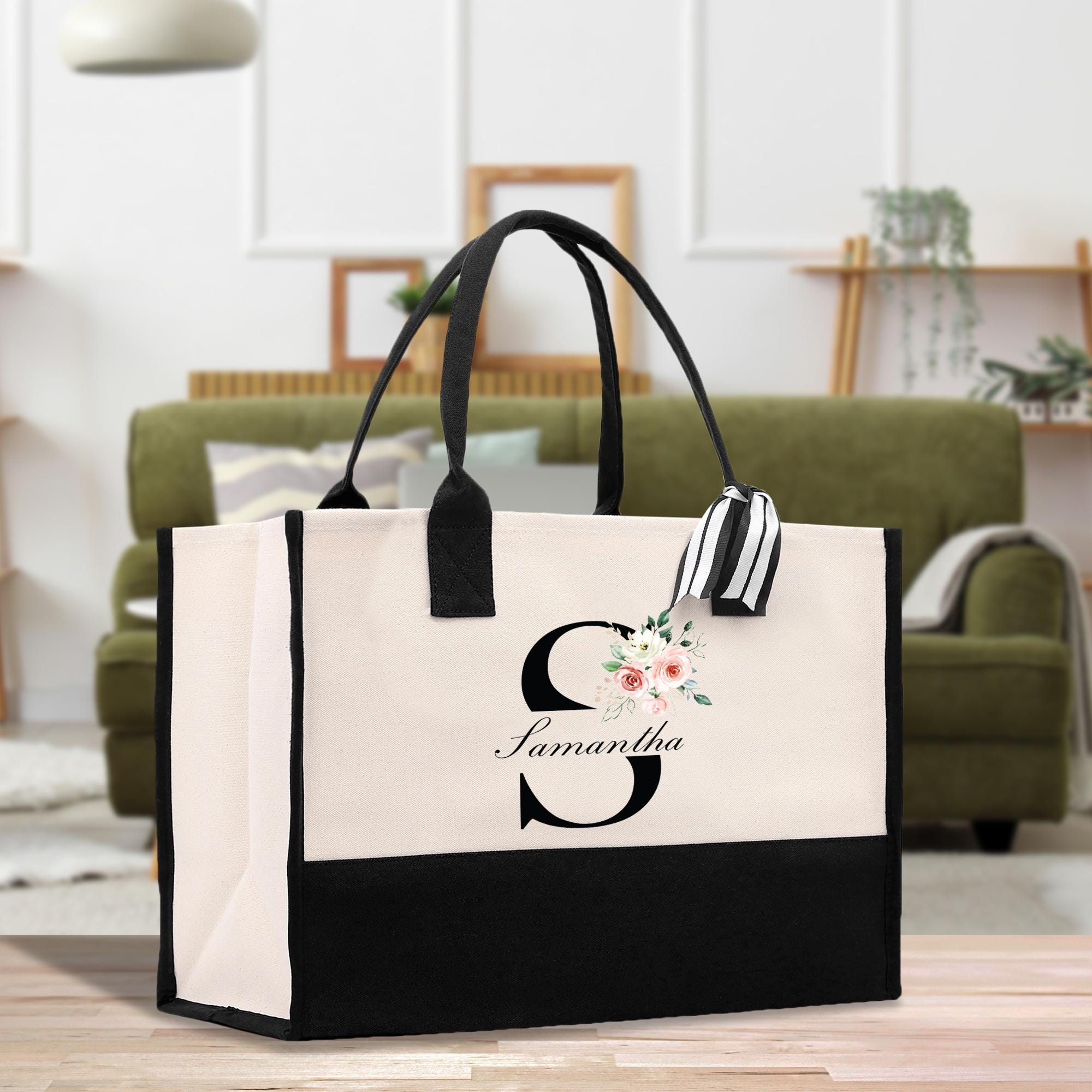 a black and white bag with a flower on it