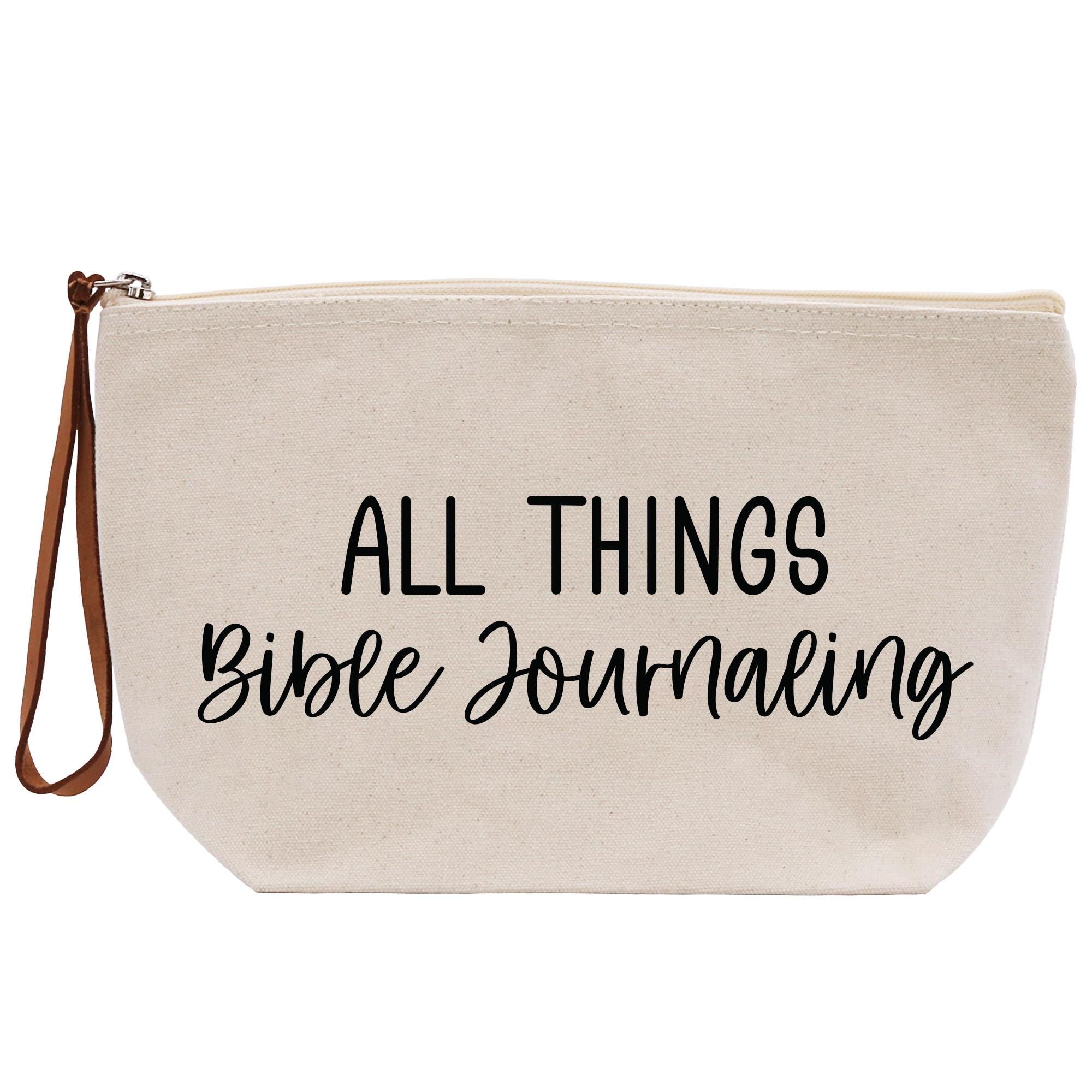 a white bag with black writing that says all things bible journaling