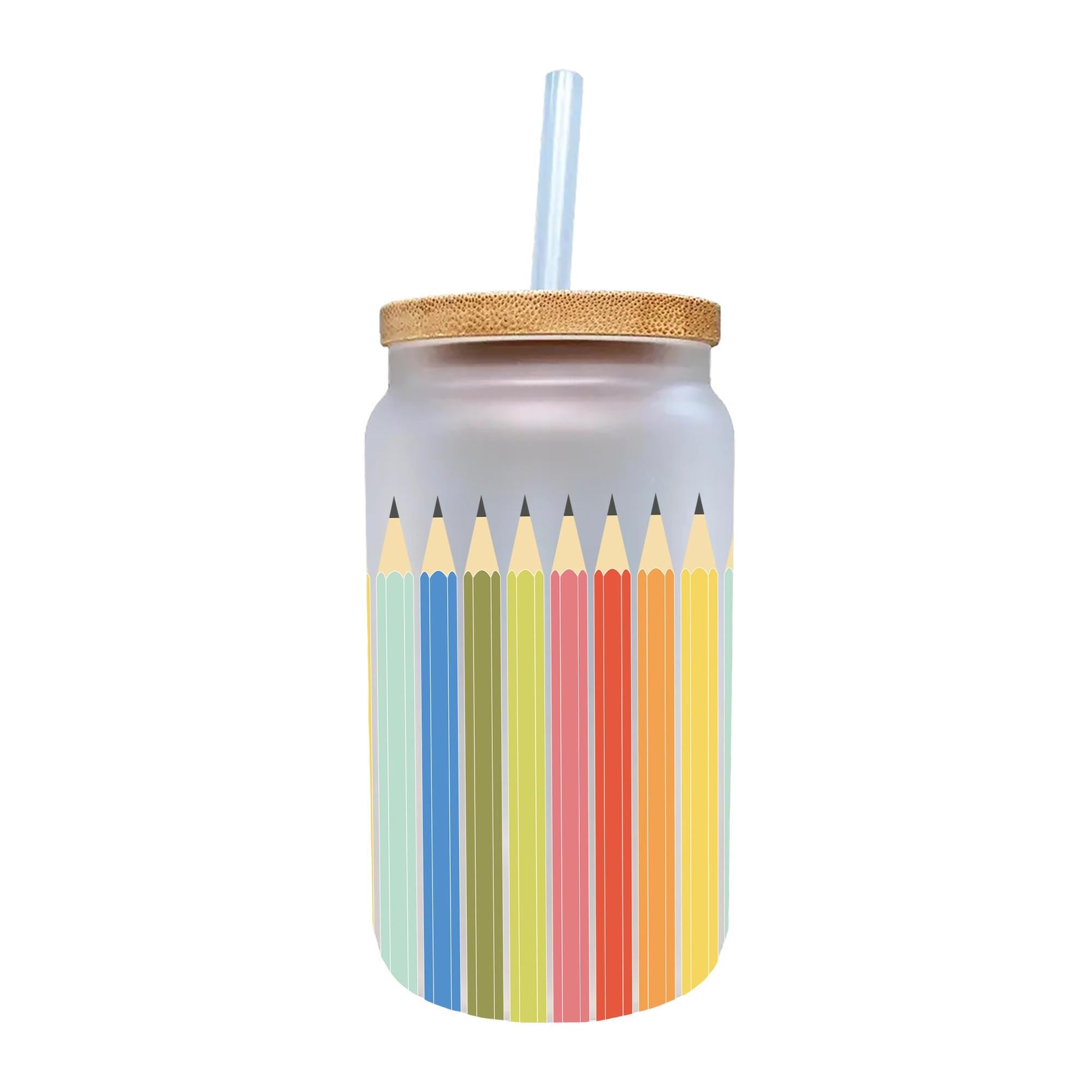 a jar of colored pencils with a straw sticking out of it