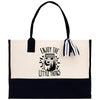 A tote bag with a black and white design featuring a jar with a crescent moon and stars, along with the text 