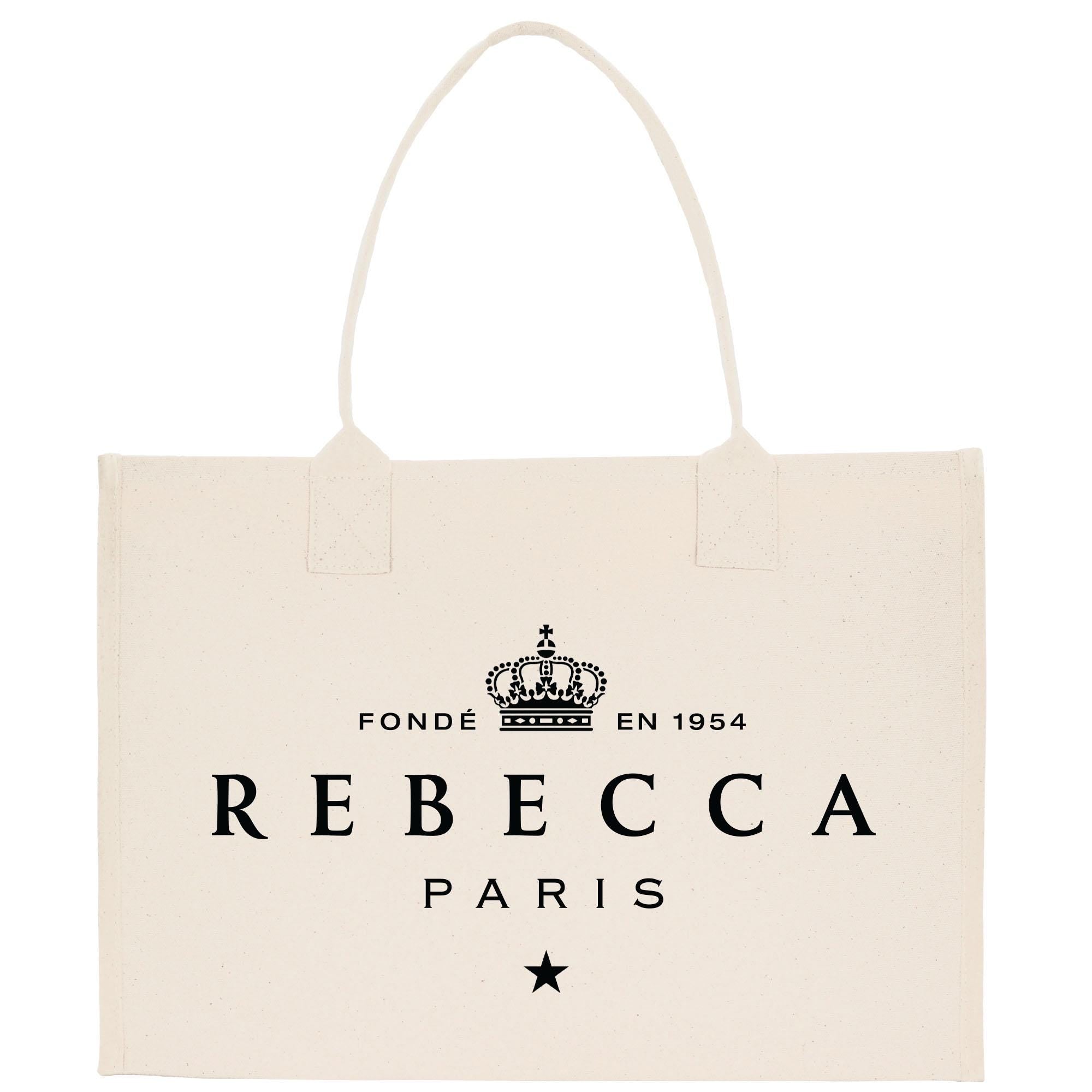a beige tote bag with the text &quot;REBECCA PARIS&quot; printed on it.