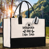 A black and white tote bag with a printed phrase 