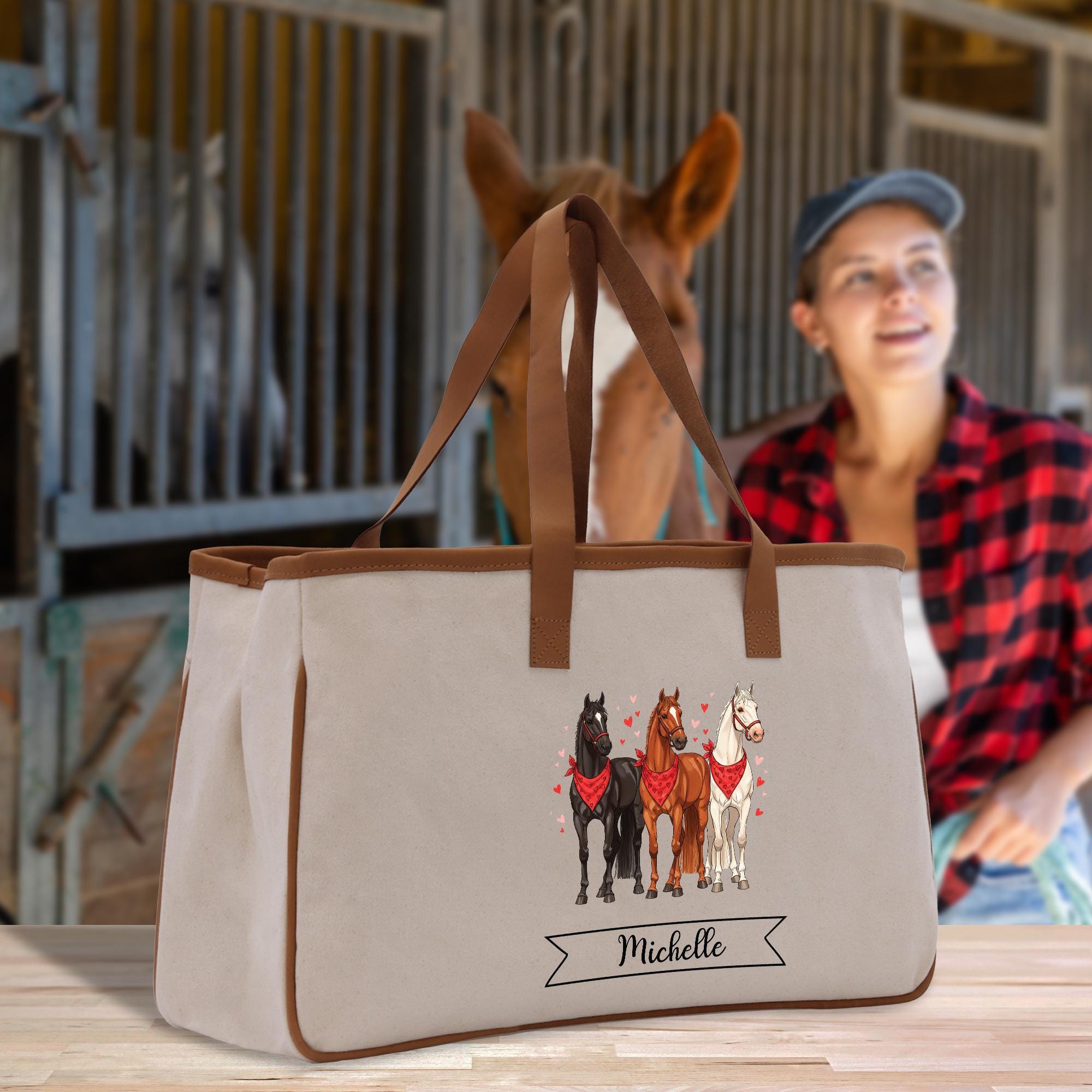 a woman sitting at a table next to a bag with horses on it