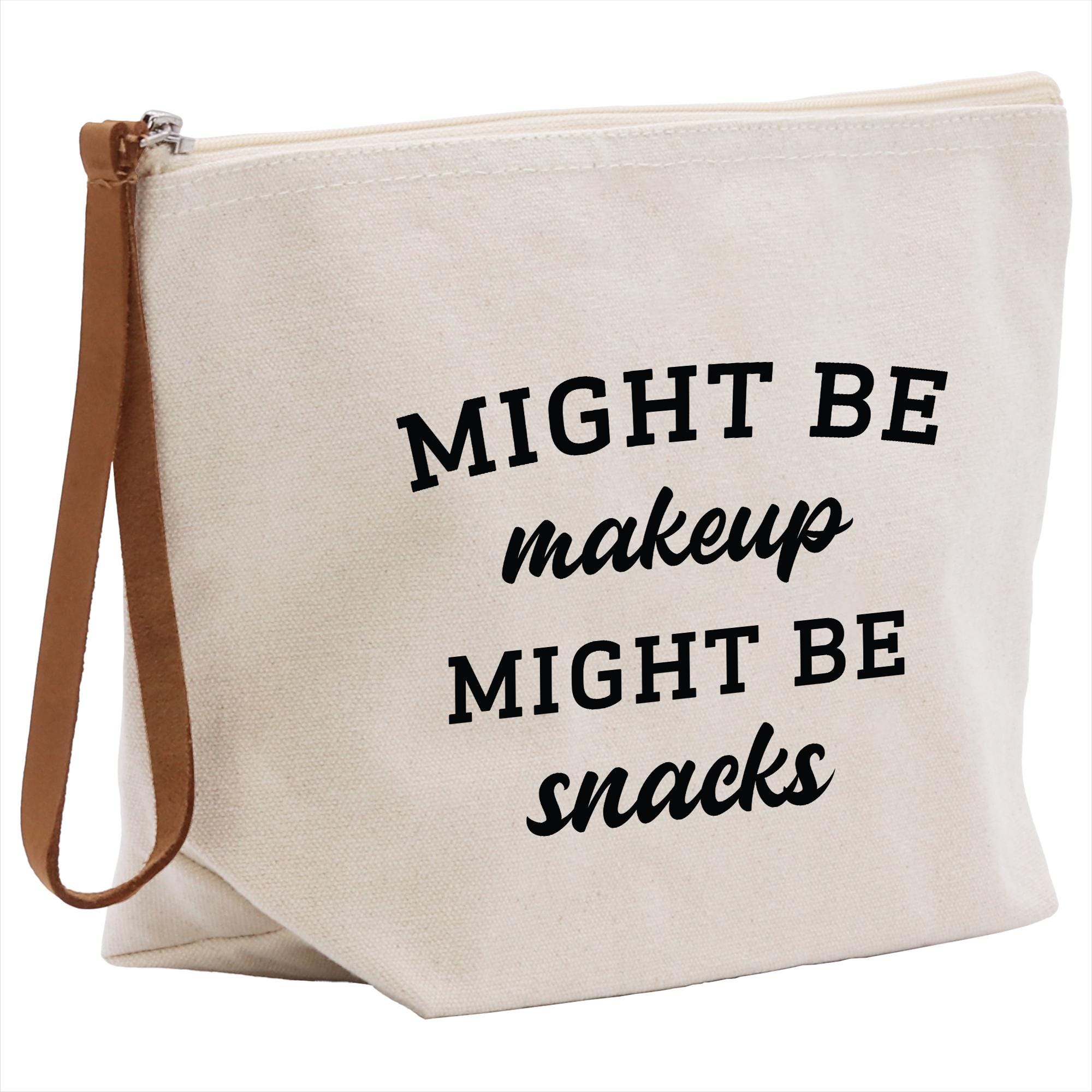 A white canvas tote bag with black text printed on it.