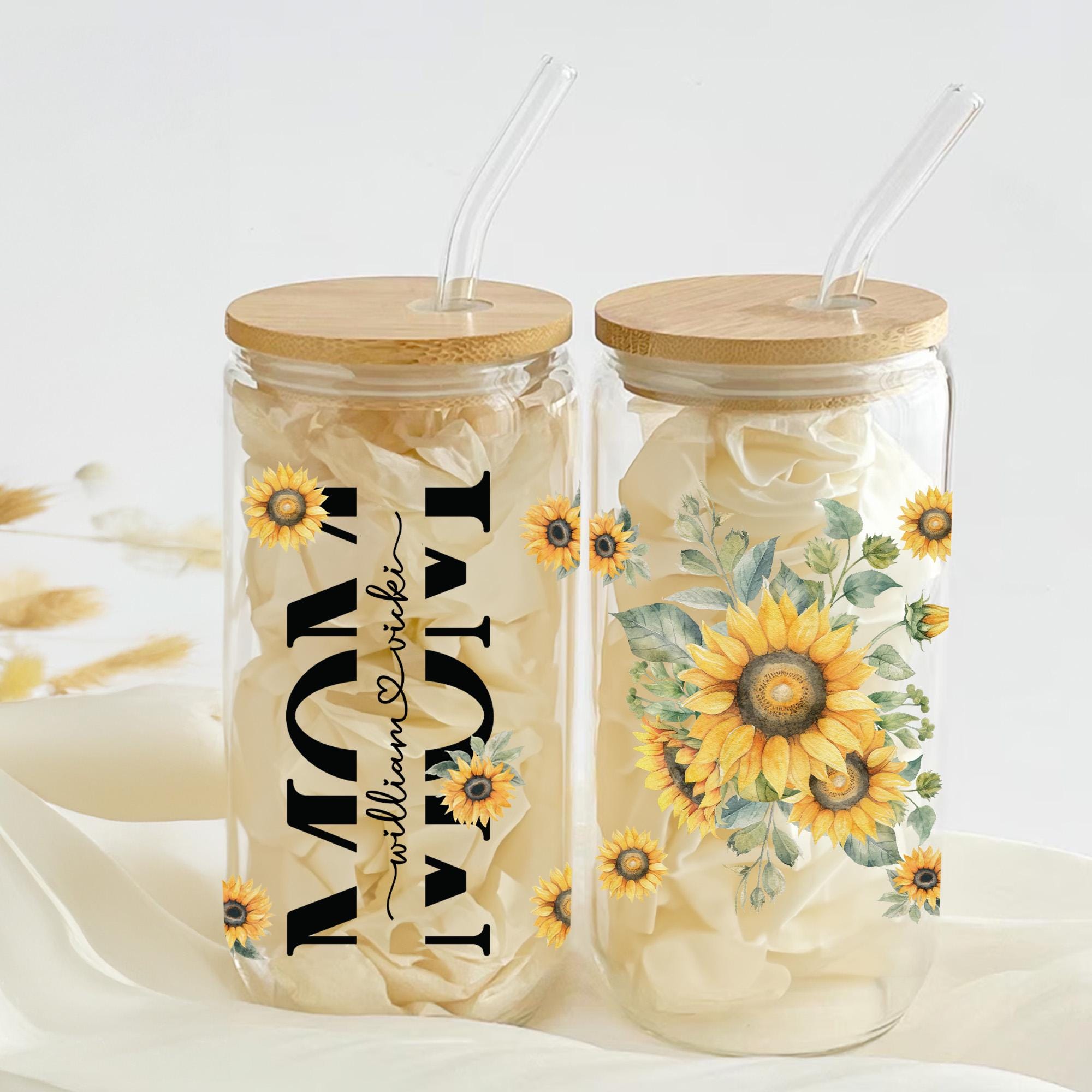 two mason jars with sunflowers painted on them