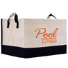 A beige and black tote bag with the text "Pool Towels" printed on it in orange.