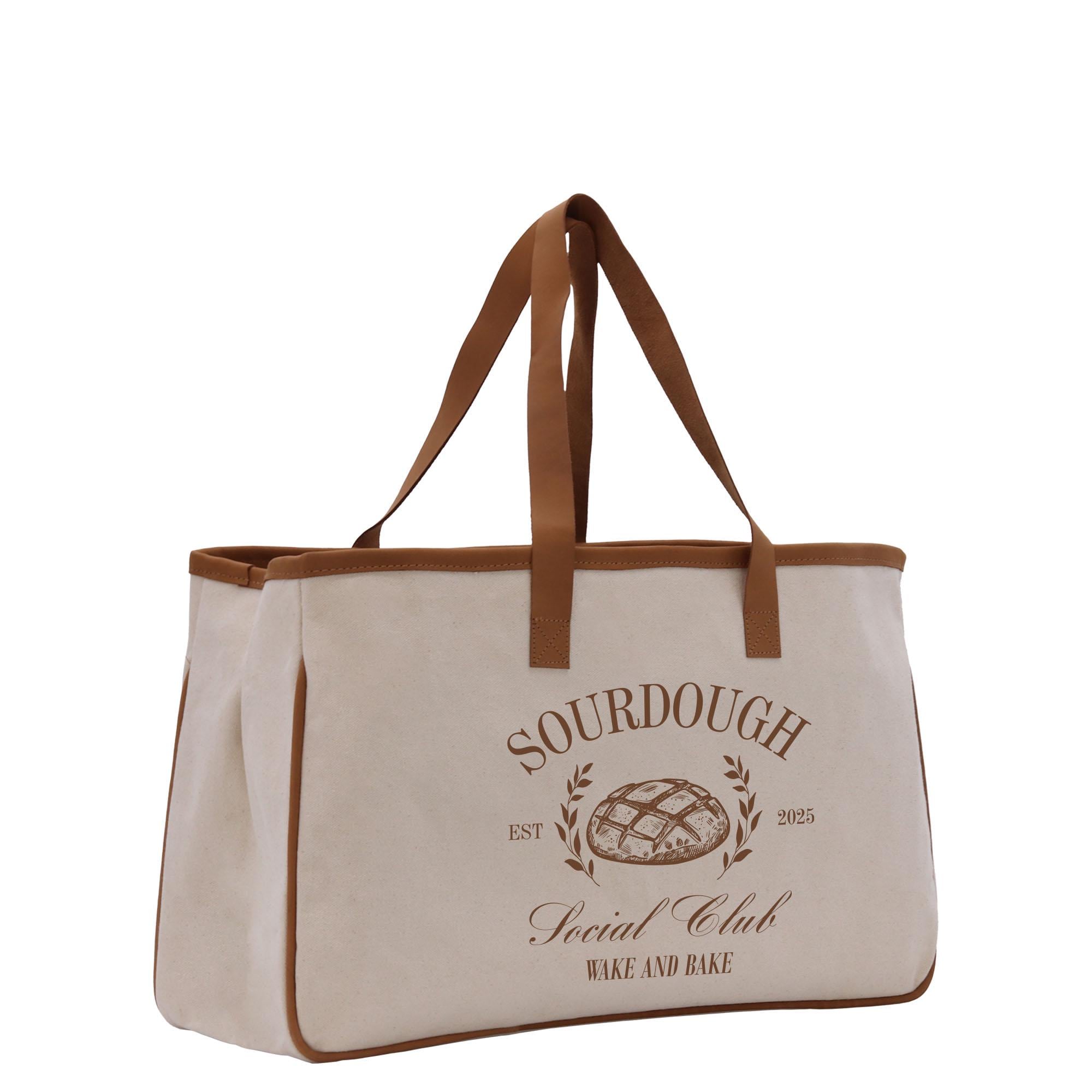 a white bag with brown handles and a logo on it
