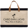 a black and white bag with a brown leather handle