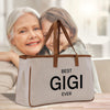 a woman holding a bag with a picture of an elderly woman on it