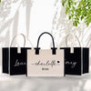three black and white shopping bags sitting on top of a table