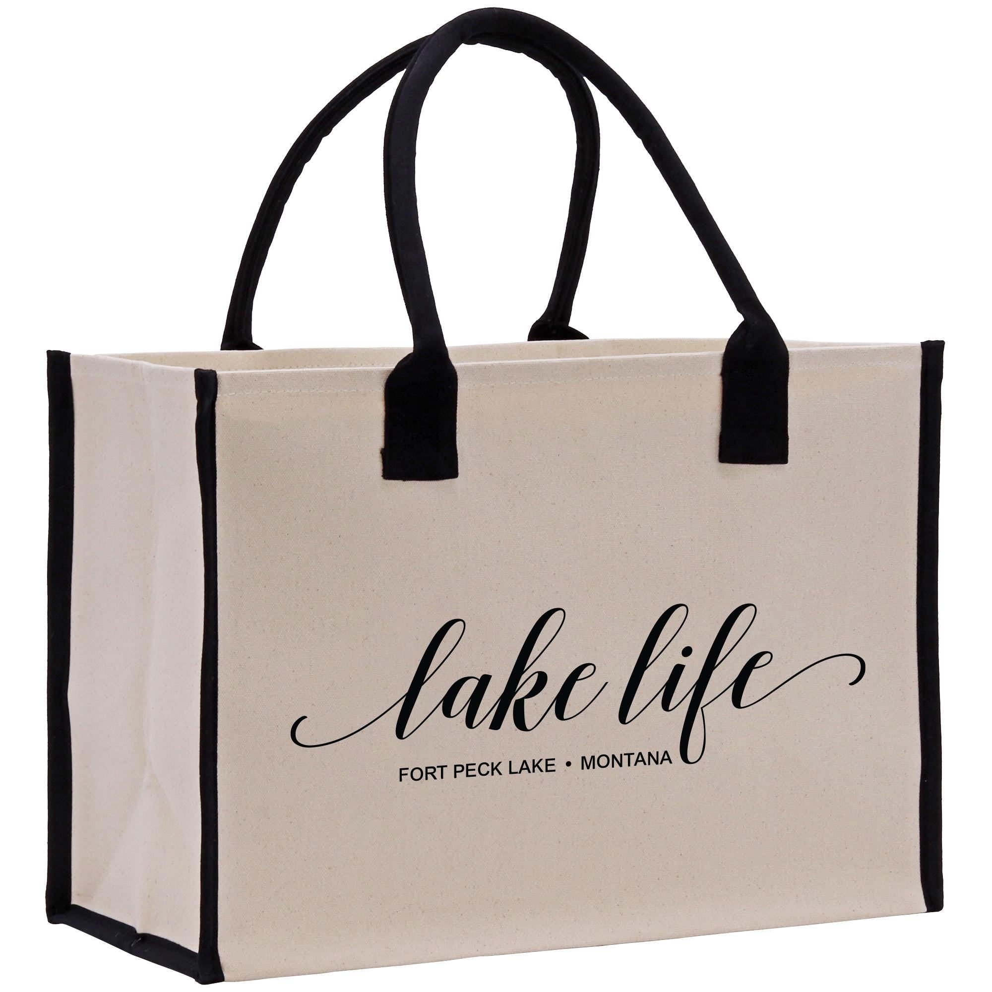 a white bag with black handles that says lake life