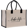 a white bag with black handles that says lake life