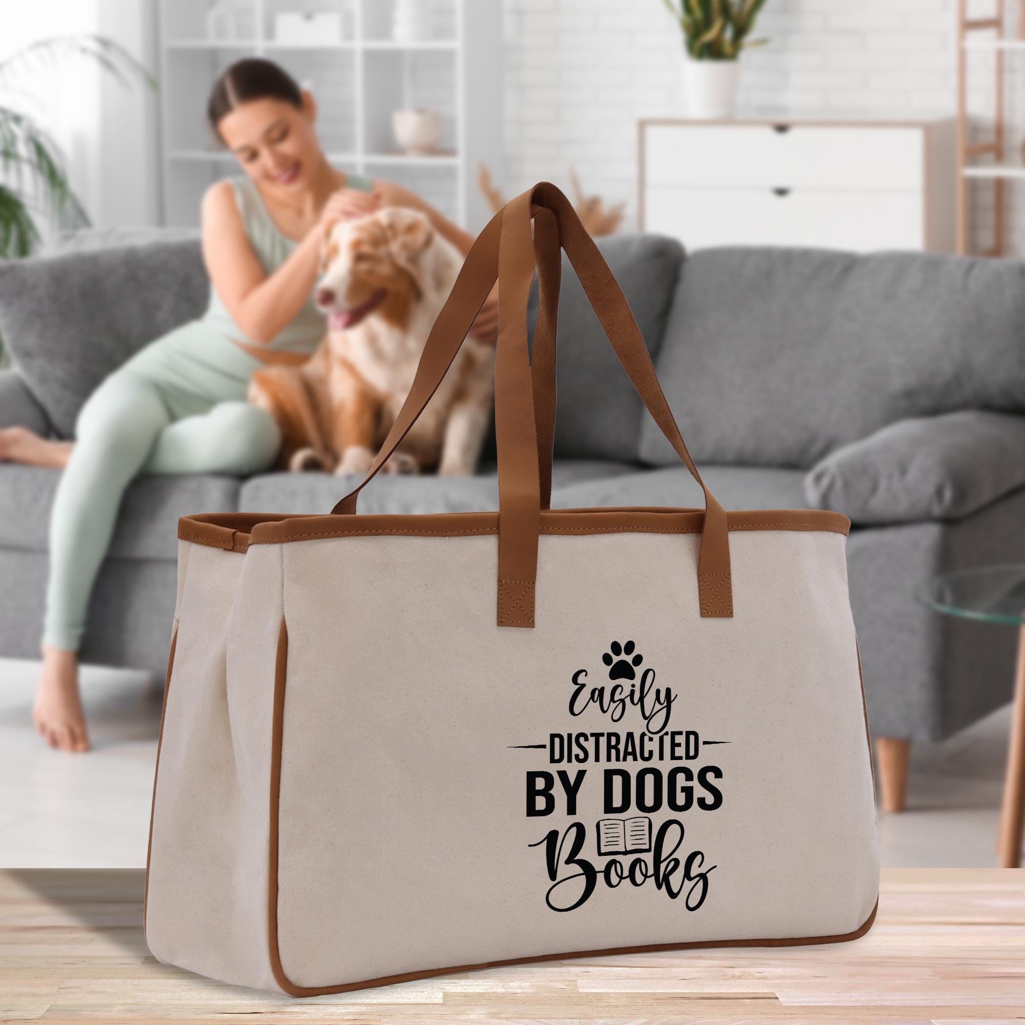 a woman sitting on a couch with a dog in front of her