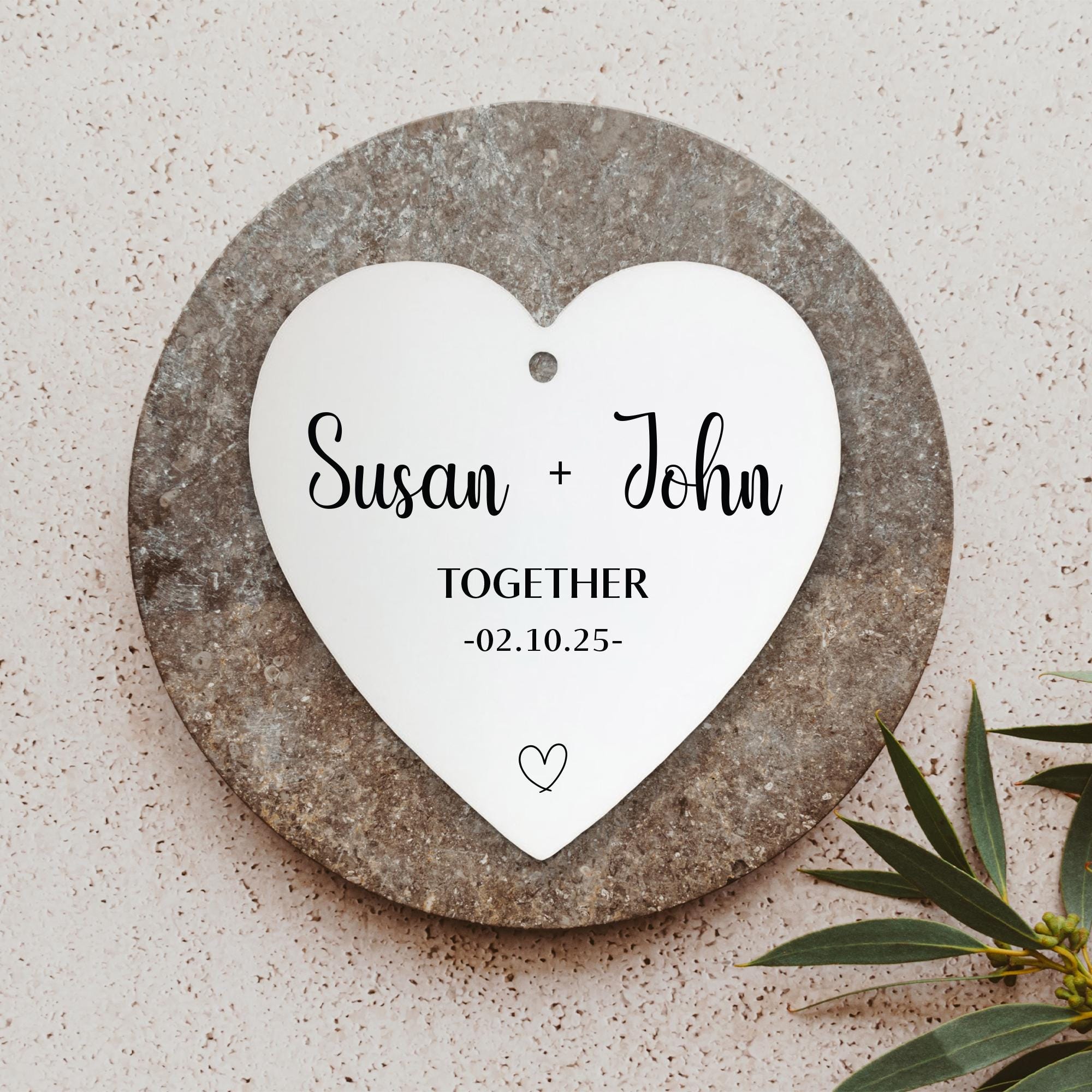 a heart shaped plaque with a couple&#39;s names on it