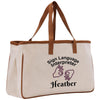 A beige canvas tote bag with a brown handle and strap, featuring a printed design that says "Sign Language Interpreter Heather" along with hand gestures.