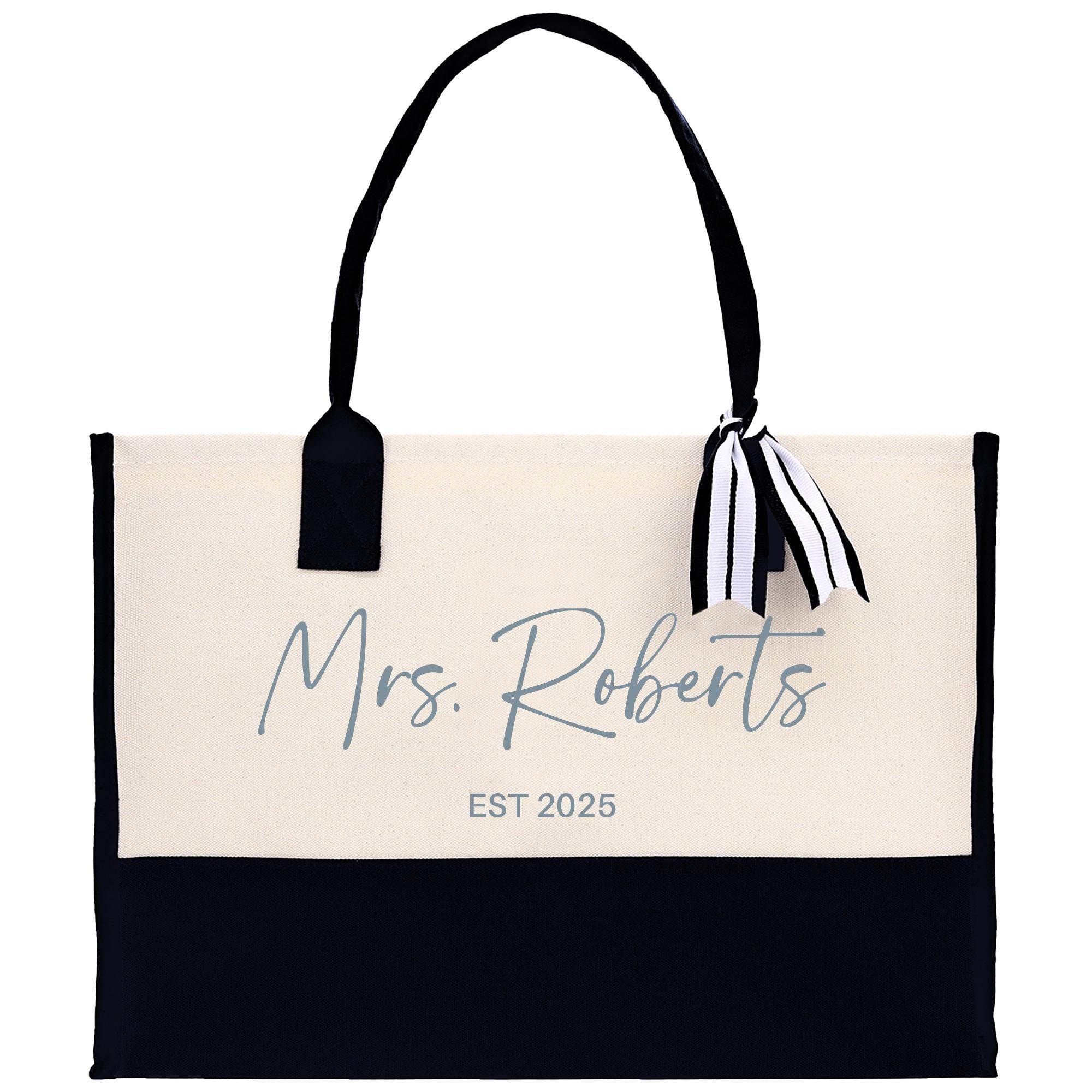 a black and white tote bag with a name on it