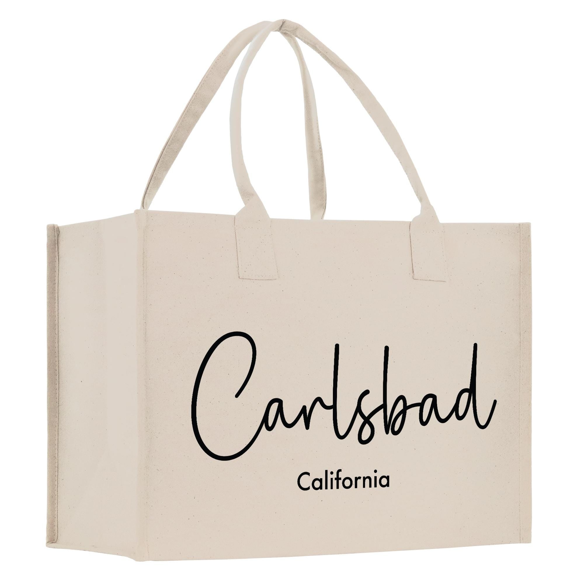A beige canvas tote bag with the text &quot;Carlsbad California&quot; printed on it.
