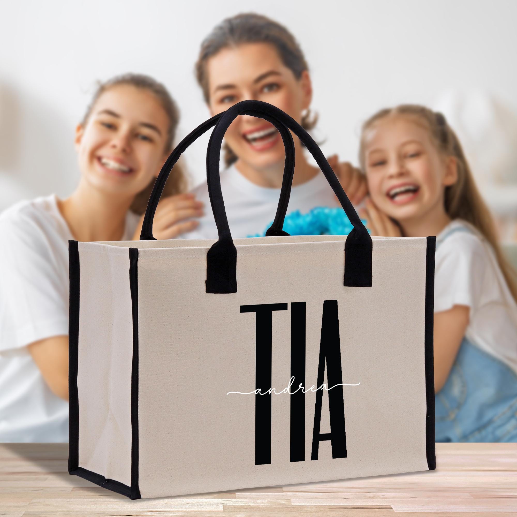 a woman and two girls sitting on a table with a shopping bag