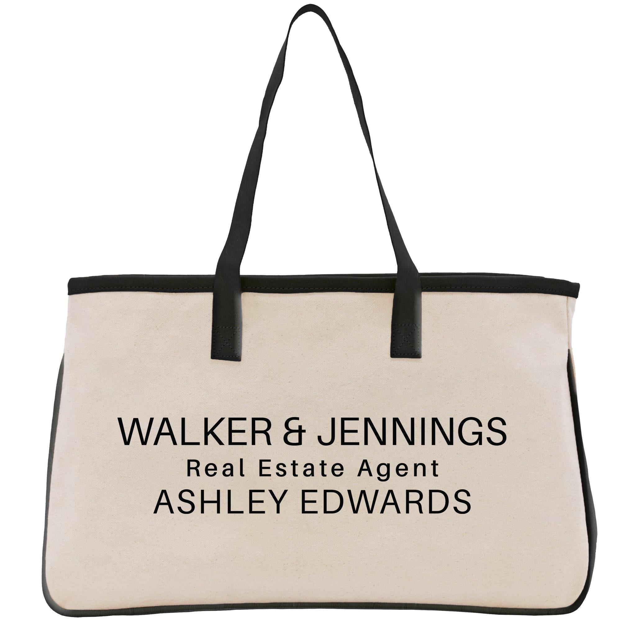 A beige canvas tote bag with black straps and handles, featuring the text &quot;WALKER & JENNINGS Real Estate Agent ASHLEY EDWARDS&quot; printed on it.