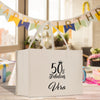 a 50th birthday gift bag sitting on a table