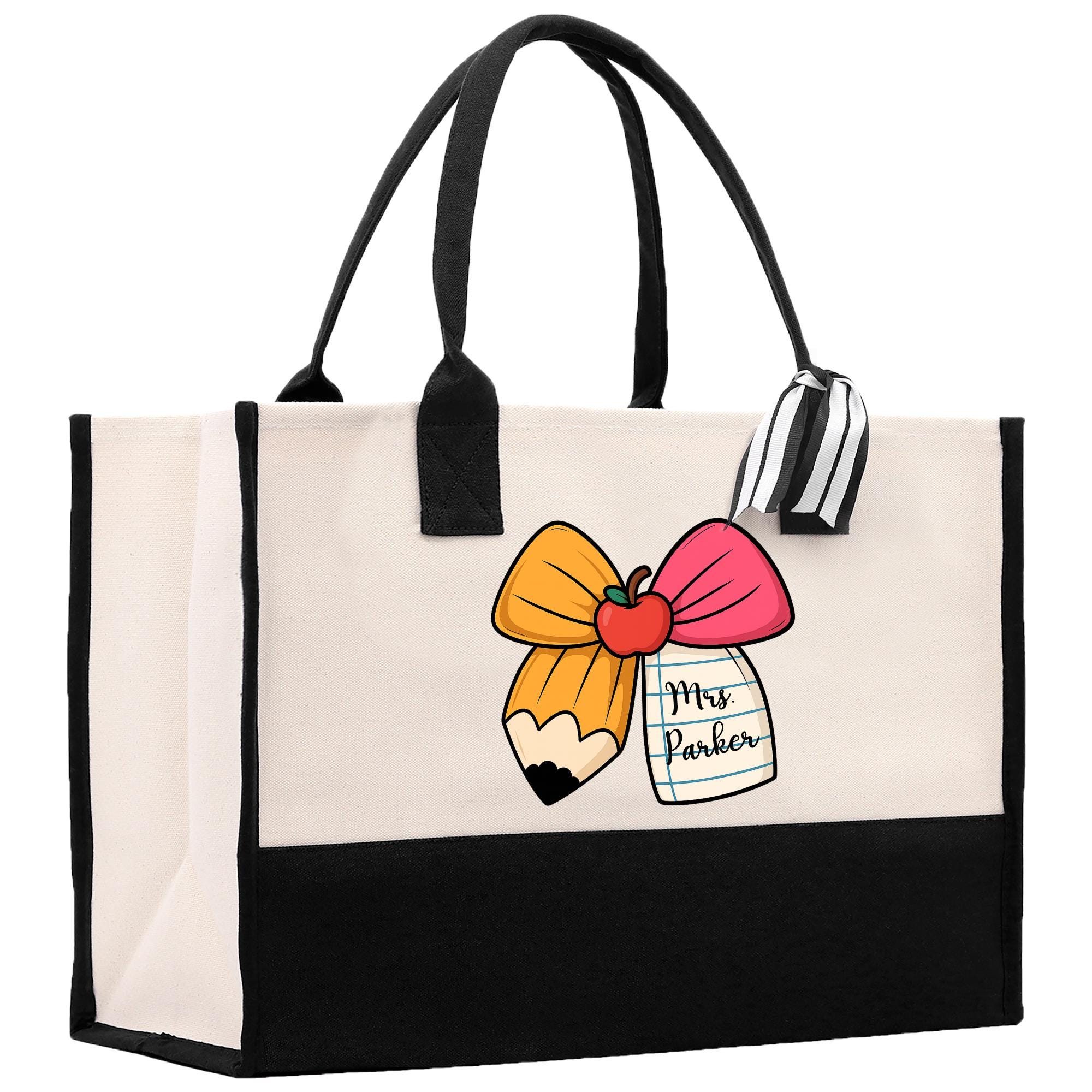 a black and white bag with a pink bow on it