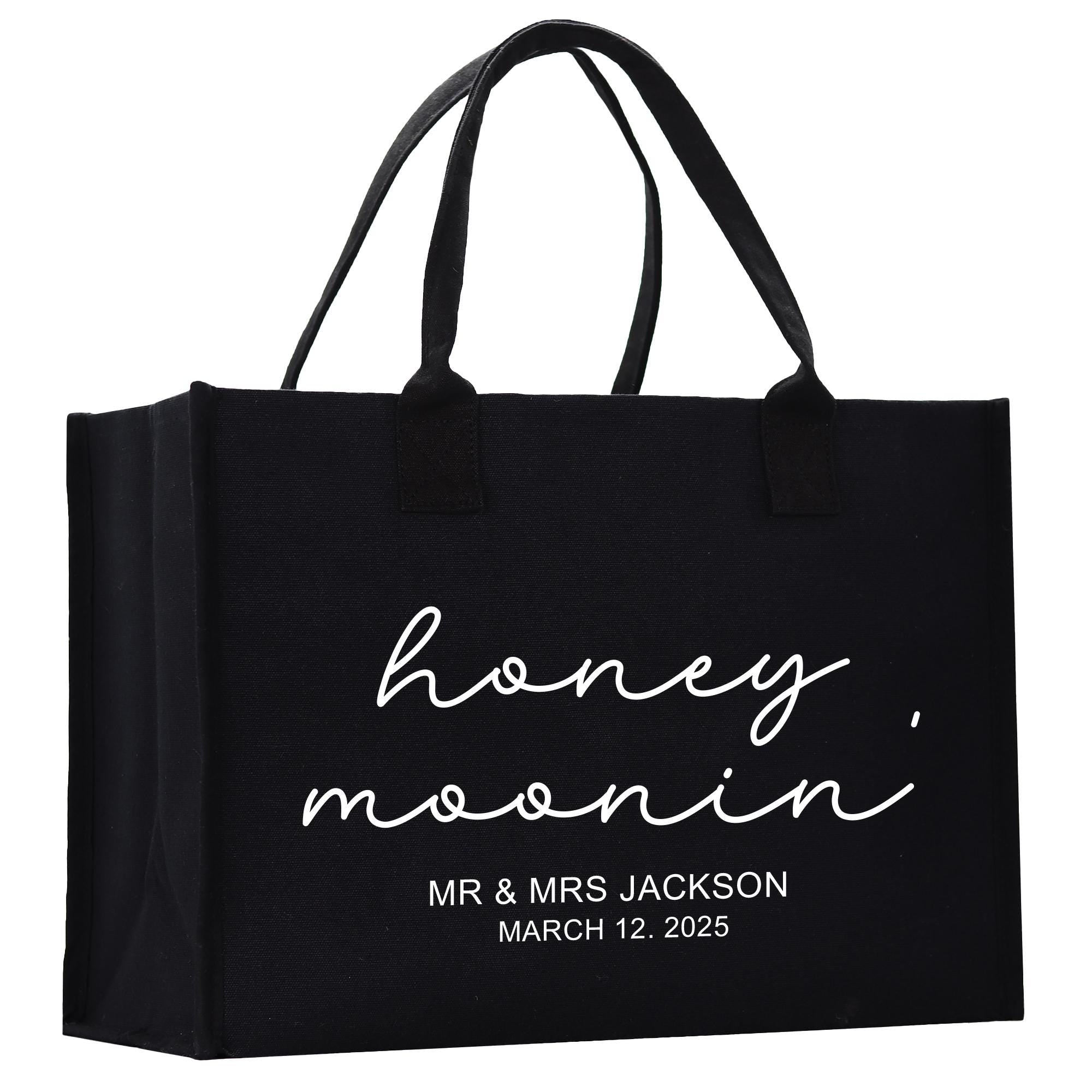 a black shopping bag with the words honey moon printed on it